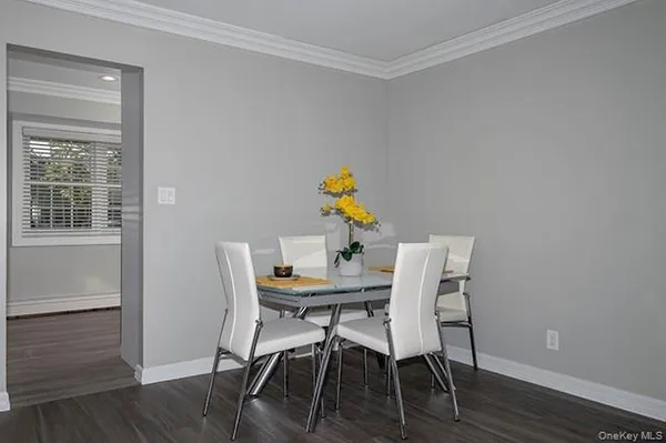 a view of a dining room with furniture and wooden floor