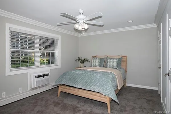 a spacious bedroom with a bed and window