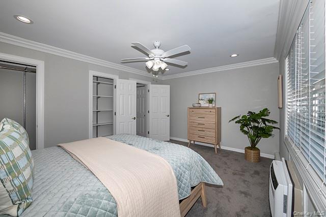 113 Terrace, Unit T01113 Bayport, NY 11705 - Photo 10 of 13 a bedroom with a bed and a chandelier