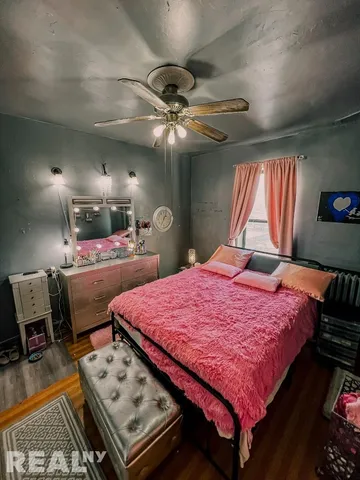 a bed room with a bed and a chandelier