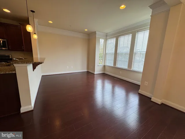 a view of a room with wooden floor and a window