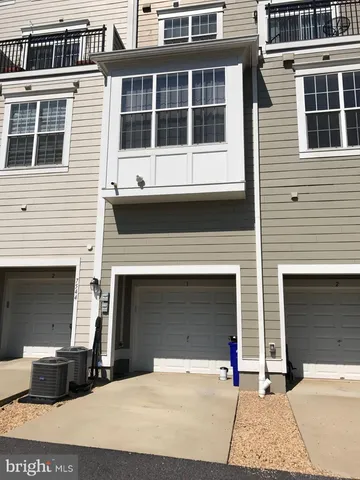 a front view of a building with a parking area