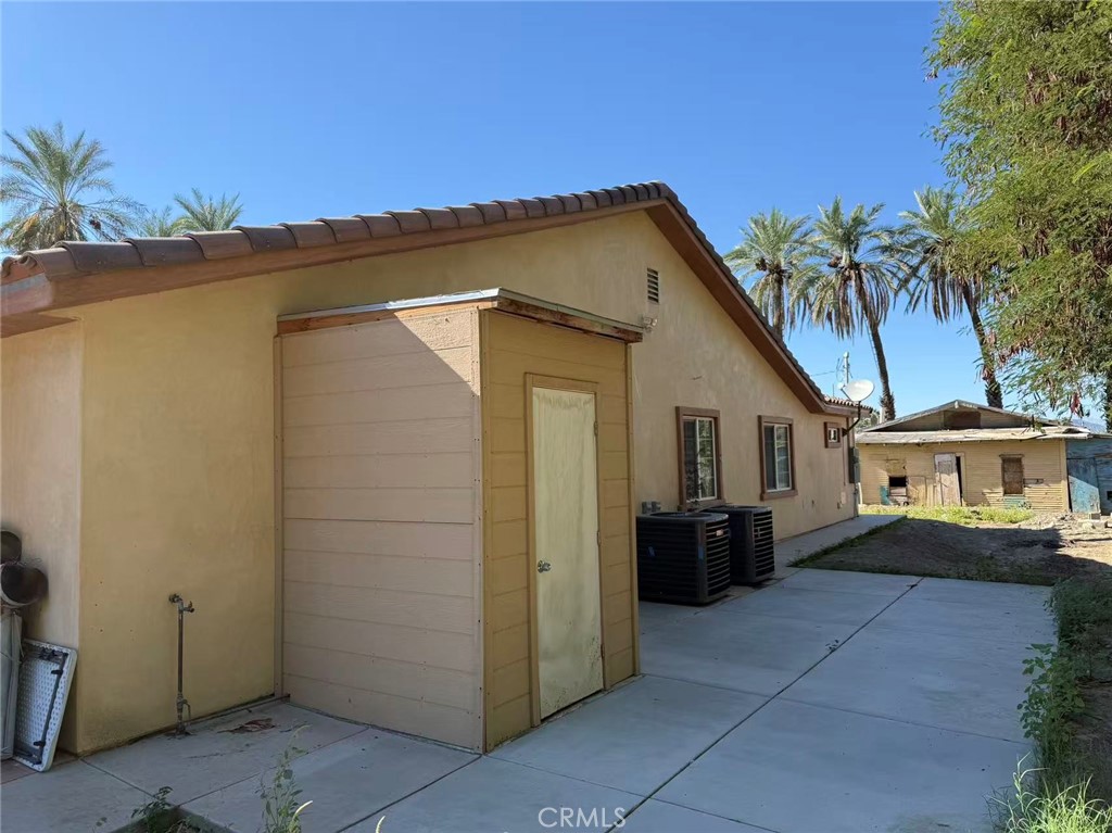 66820 Harrison Street Thermal, CA 92274 - Photo 5 of 11 a view of a house with backyard and trees