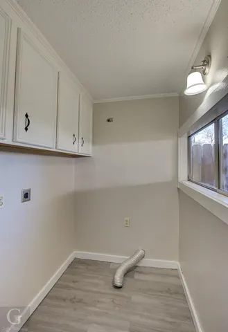 a view of a livingroom with wooden floor and window
