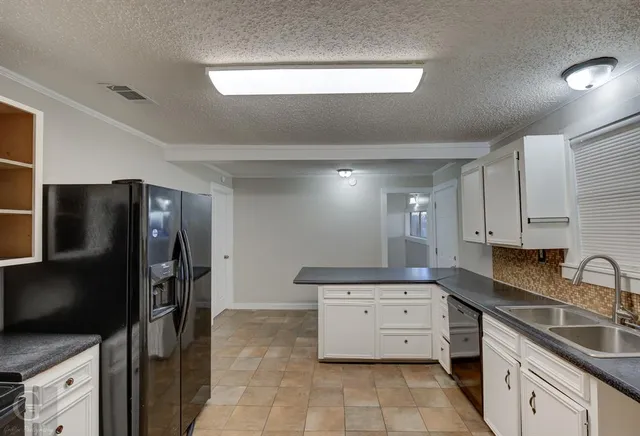 a kitchen with stainless steel appliances a refrigerator sink and stove