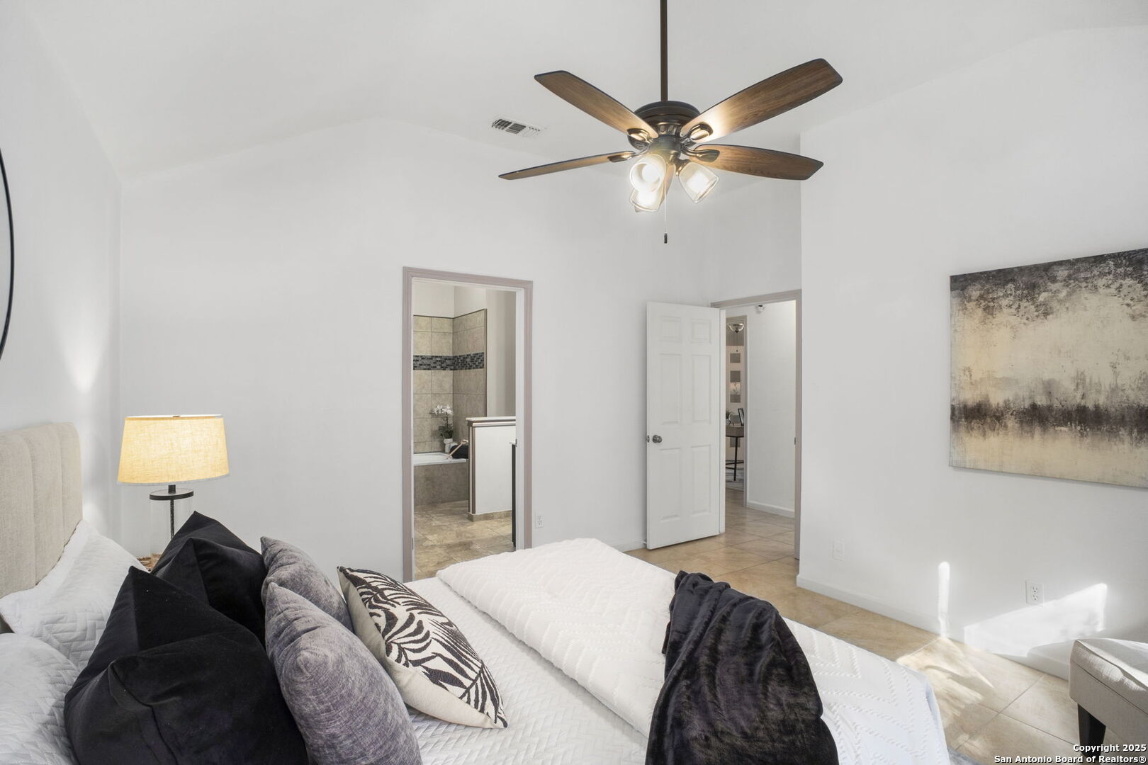 7562 Beaver Tree San Antonio, TX 78249 - Photo 17 of 30 a bedroom with a bed and a chandelier