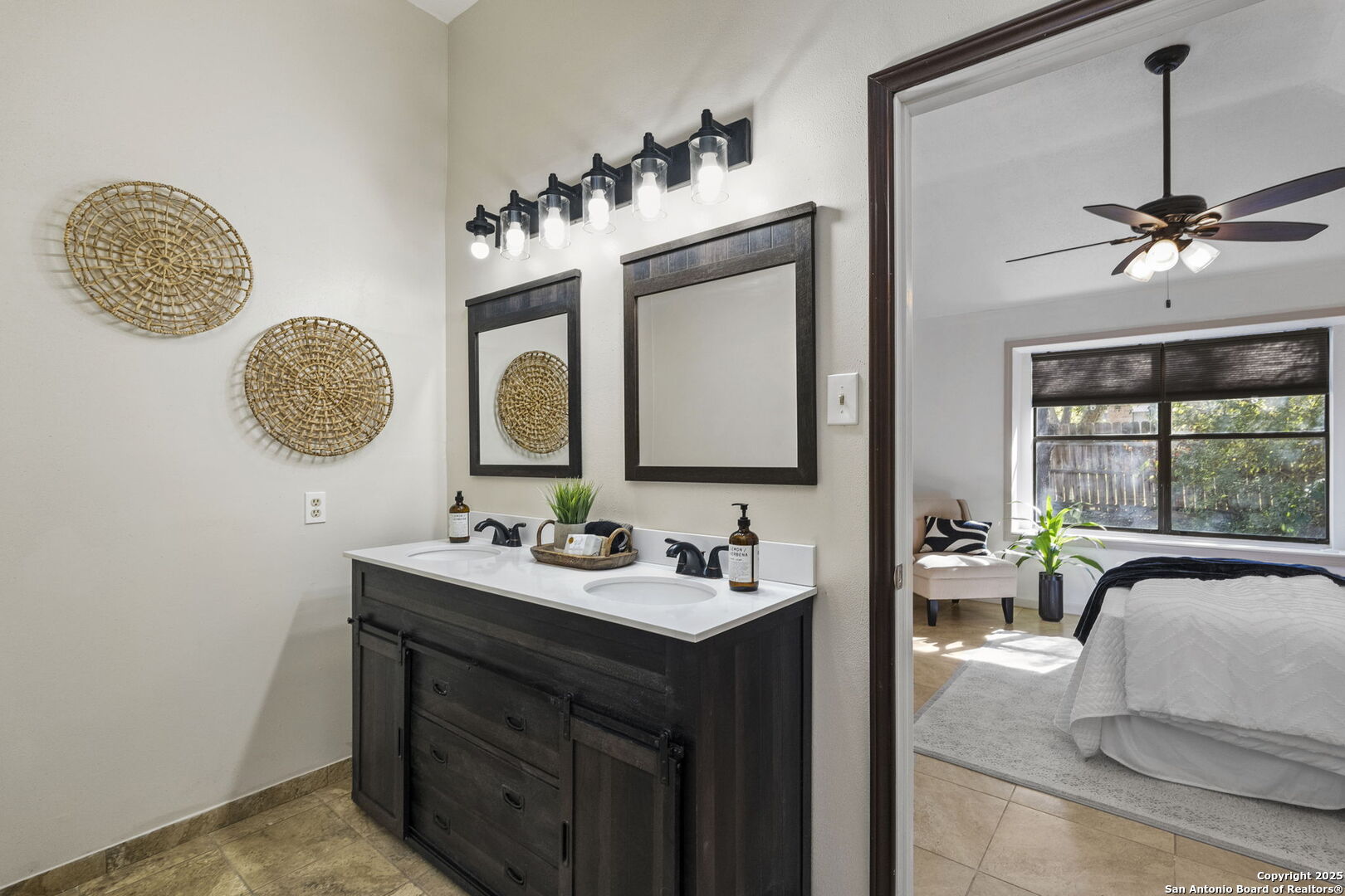 7562 Beaver Tree San Antonio, TX 78249 - Photo 18 of 30 a en suite bathroom with a double vanity sink and a mirror