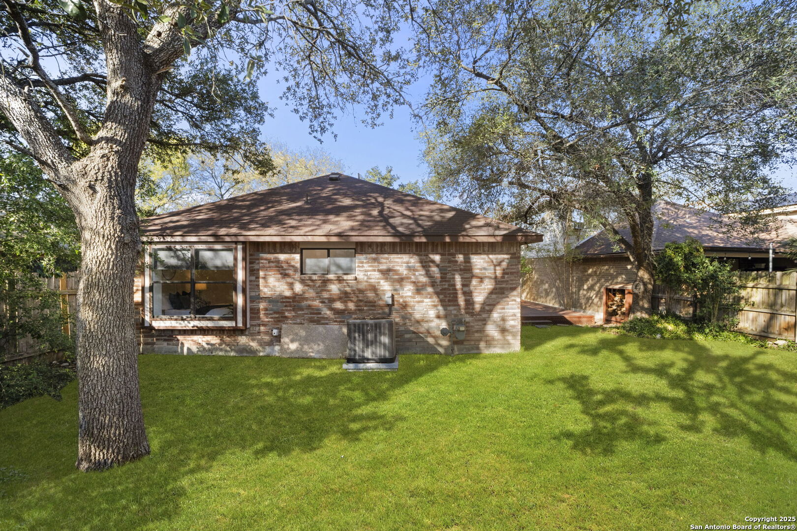 7562 Beaver Tree San Antonio, TX 78249 - Photo 25 of 30 a view of a house with backyard and a tree