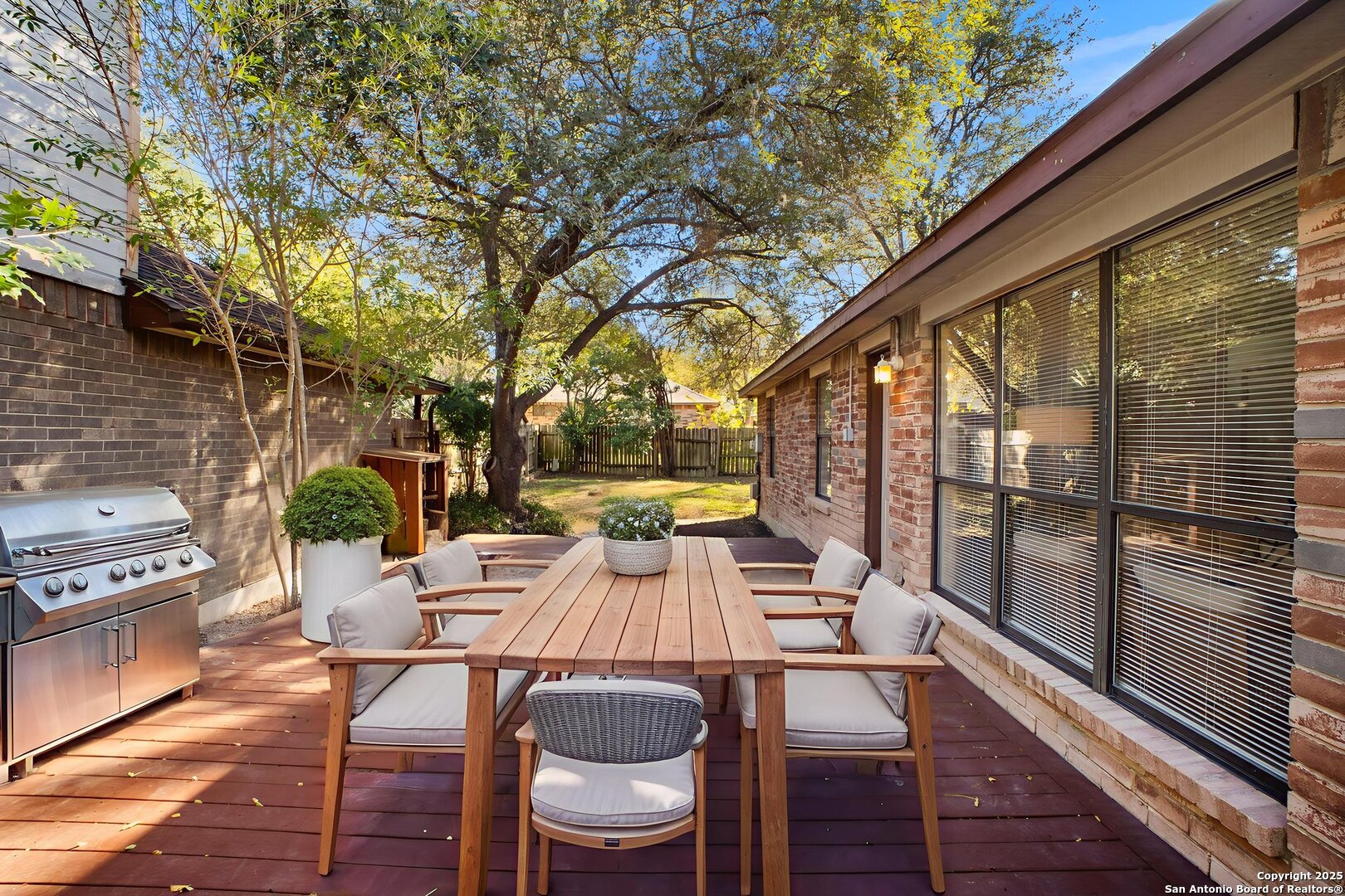 7562 Beaver Tree San Antonio, TX 78249 - Photo 28 of 30 a view of a patio with table and chairs and wooden floor
