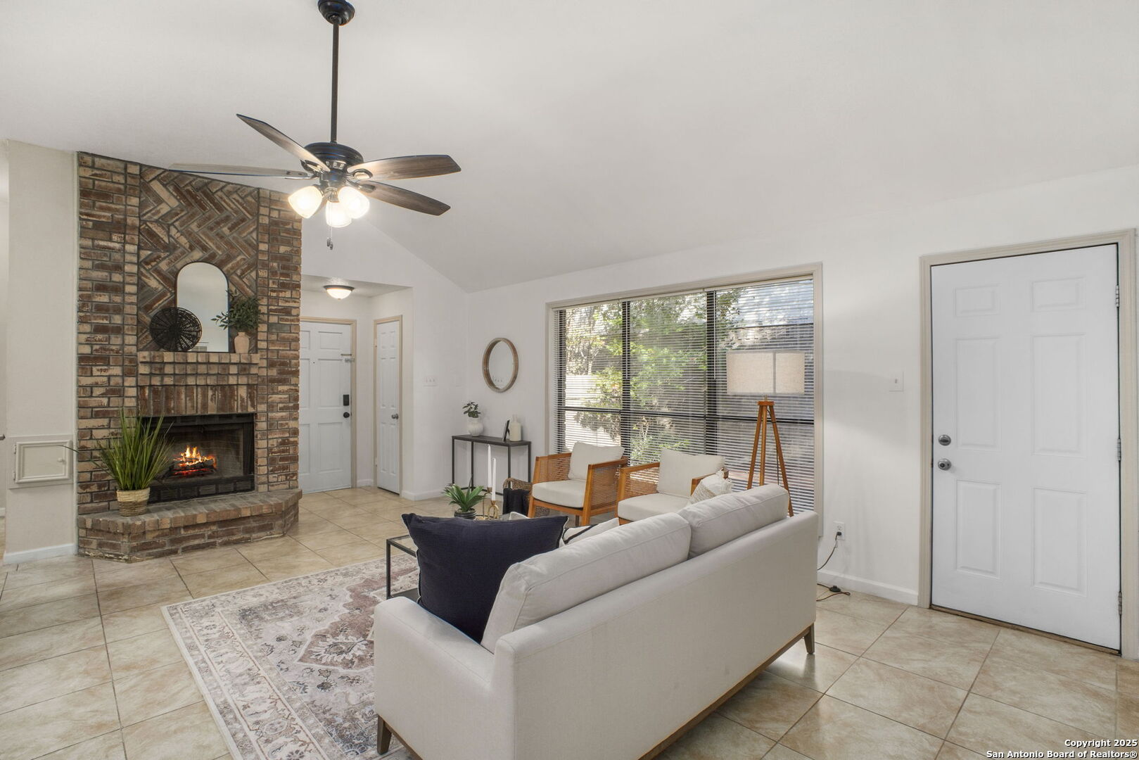 7562 Beaver Tree San Antonio, TX 78249 - Photo 4 of 30 a living room with furniture a fireplace and a chandelier