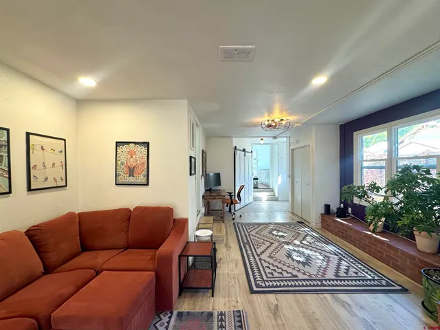 a living room with furniture and a potted plant