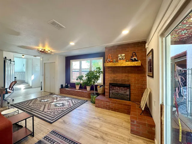 a living room with furniture and a fireplace