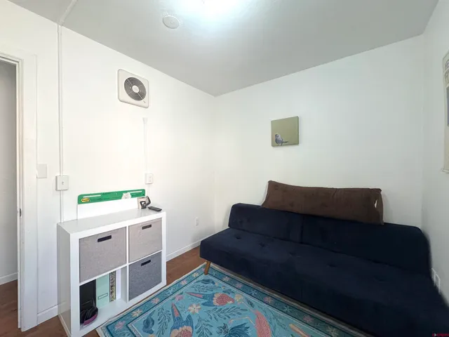 a living room with a couch and a stove next to a window