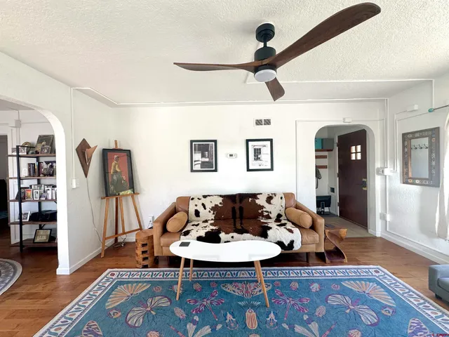 a living room with furniture and a wooden floor