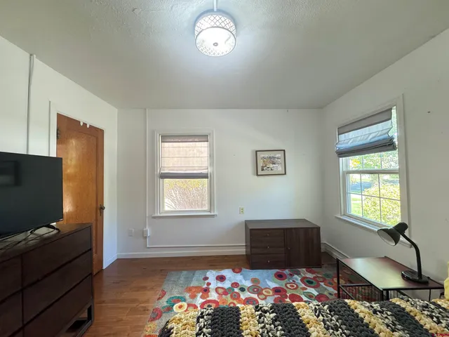 a living room with furniture rug and window
