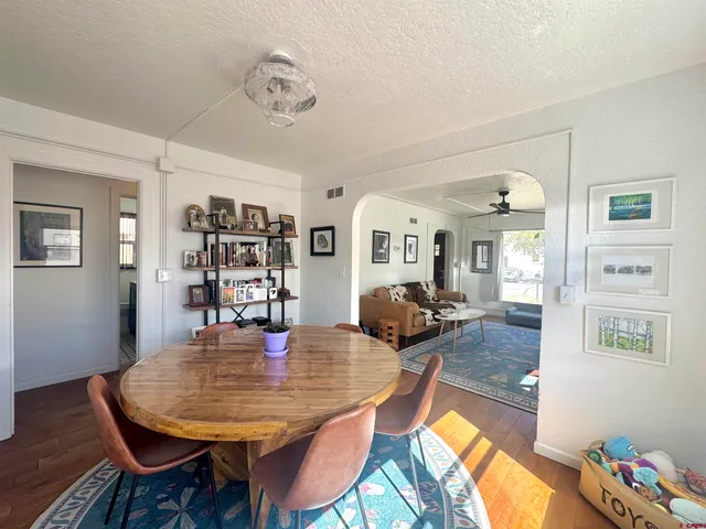 a view of a dining room with furniture and wooden floor