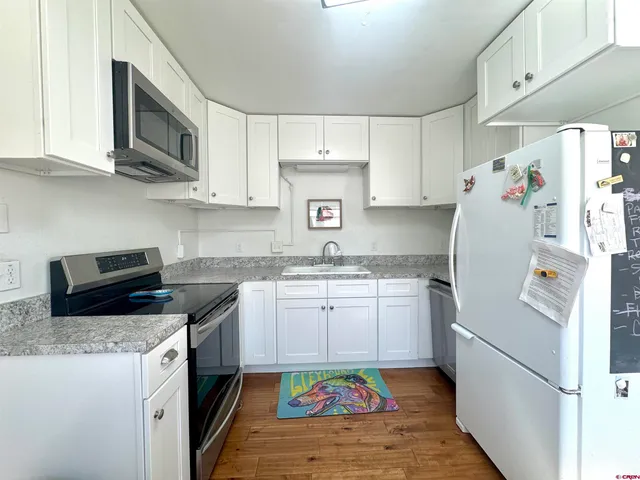 a kitchen with a sink a stove and refrigerator