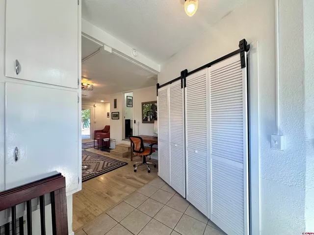a view of a bedroom with a window and storage