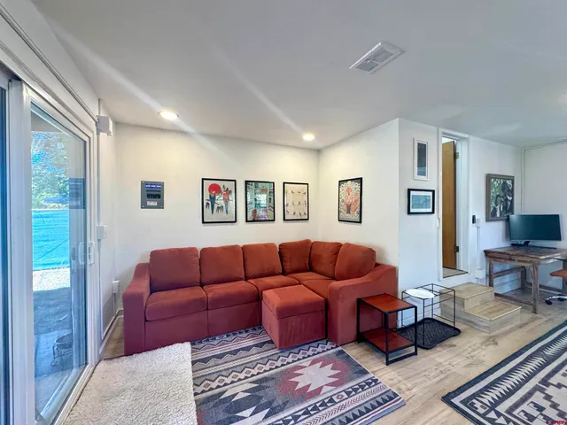 a living room with furniture ceiling fan and a rug