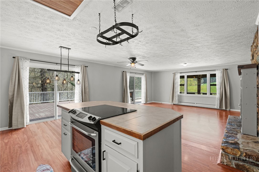 2345 Watauga River Road Sugar Grove, NC 28679 - Photo 10 of 50 a kitchen with granite countertop a stove a sink and wooden floor