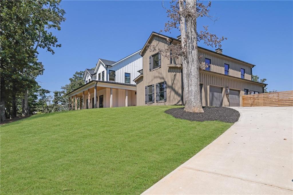 5525 Hubbard Town Road Cumming, GA 30028 - Photo 11 of 84 a front view of a house with a garden