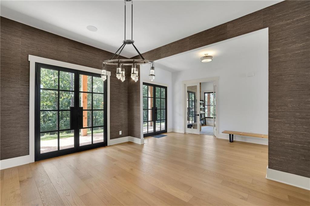 5525 Hubbard Town Road Cumming, GA 30028 - Photo 19 of 84 a view of an empty room with a window and wooden floor