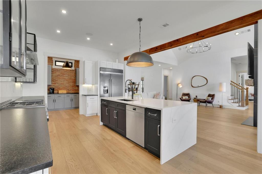 5525 Hubbard Town Road Cumming, GA 30028 - Photo 29 of 84 a large kitchen with stainless steel appliances a large counter top a stove and a refrigerator