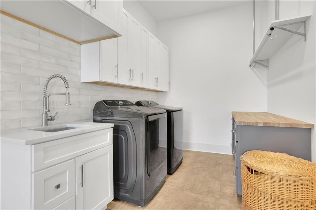 5525 Hubbard Town Road Cumming, GA 30028 - Photo 32 of 84 a utility room with sink dryer and washer