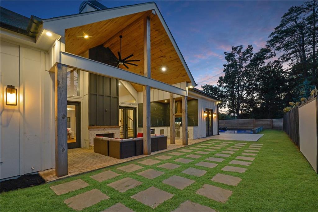 5525 Hubbard Town Road Cumming, GA 30028 - Photo 5 of 84 a view of a porch with furniture and floor to ceiling window