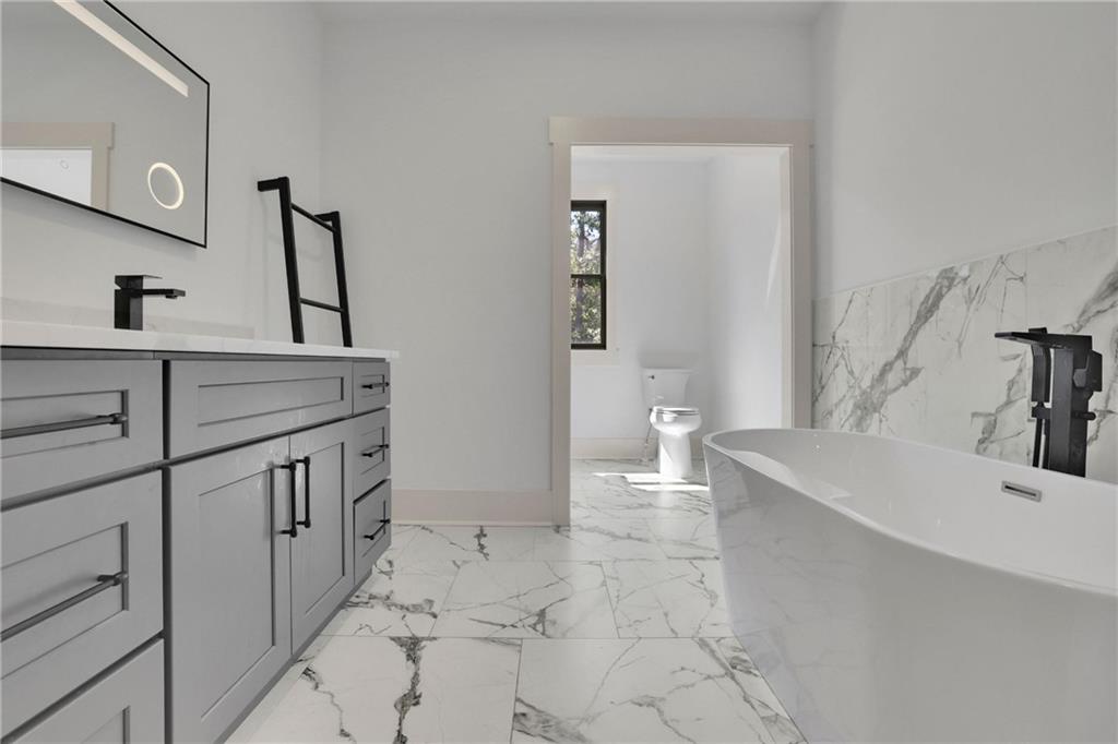 5525 Hubbard Town Road Cumming, GA 30028 - Photo 52 of 84 a bathroom with a sink a toilet and mirror