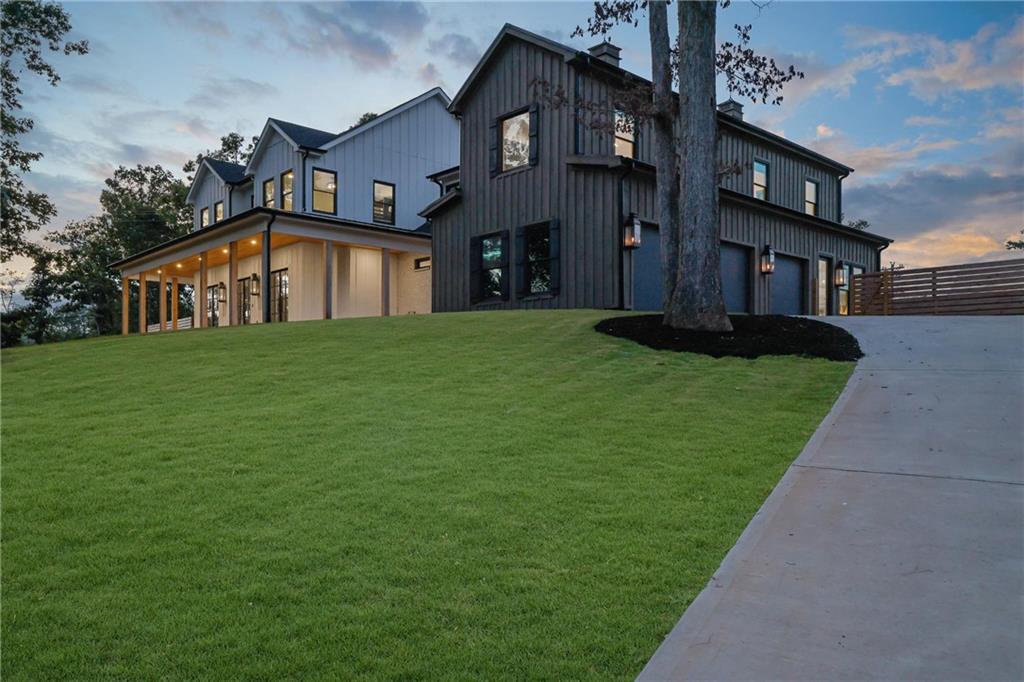 5525 Hubbard Town Road Cumming, GA 30028 - Photo 74 of 84 a front view of a house with garden