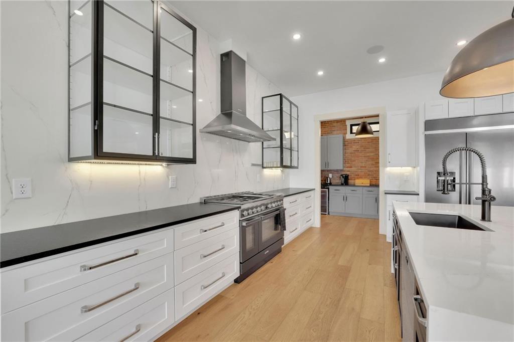 5525 Hubbard Town Road Cumming, GA 30028 - Photo 8 of 84 a large kitchen with stainless steel appliances lots of counter space and a sink
