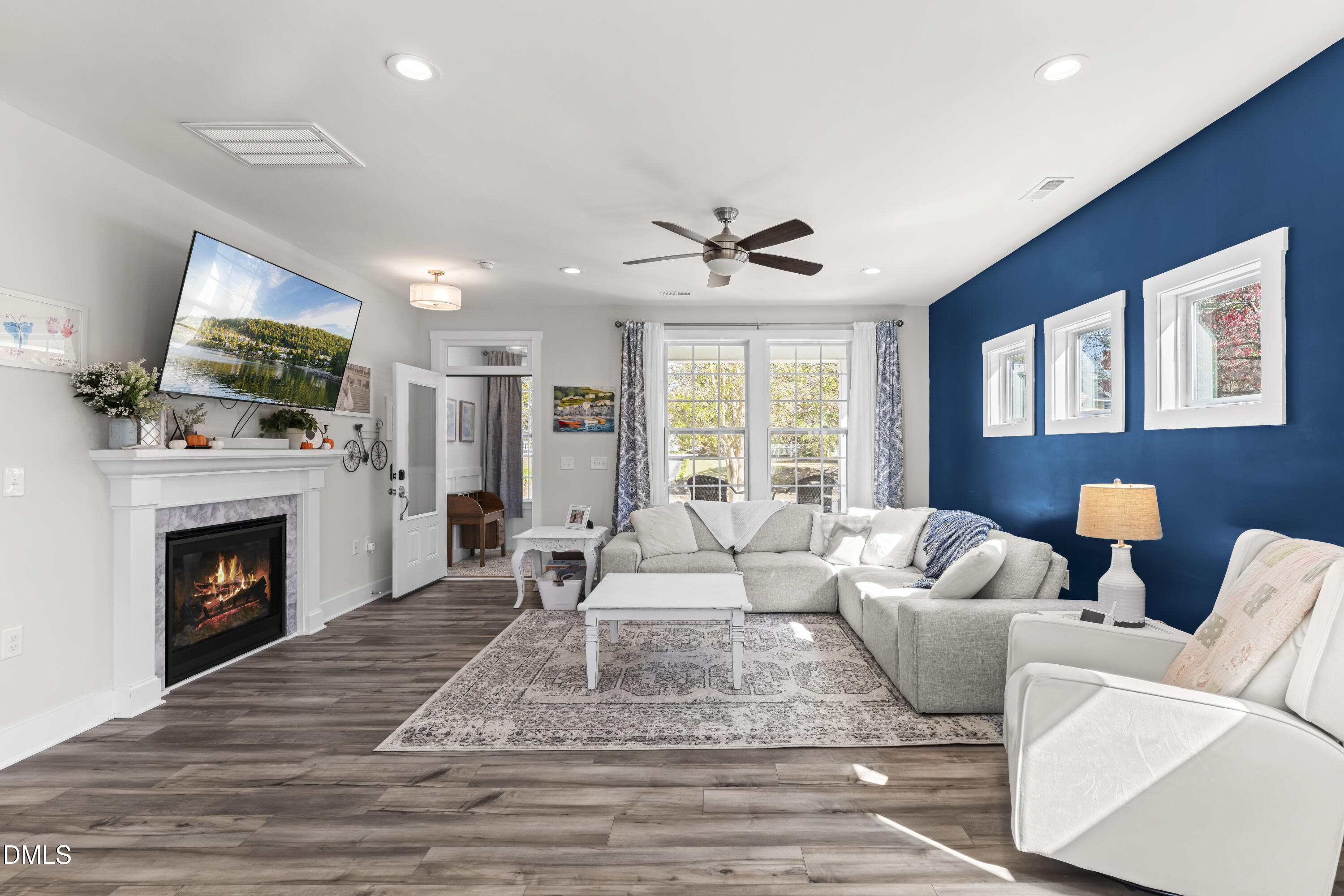 108 Bridge Street Smithfield, NC 27577 - Photo 5 of 48 a living room with furniture a flat screen tv and a fireplace