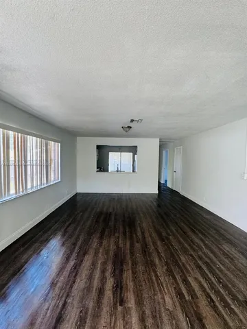a view of a room with wooden floor
