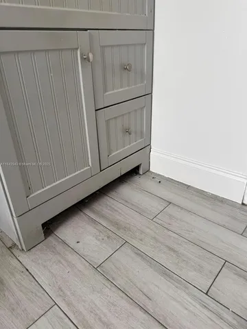a view of a utility room with cabinet