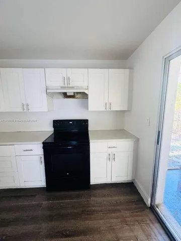 a kitchen with granite countertop a refrigerator and a stove