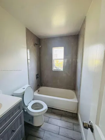 a bathroom with a toilet and a bathtub