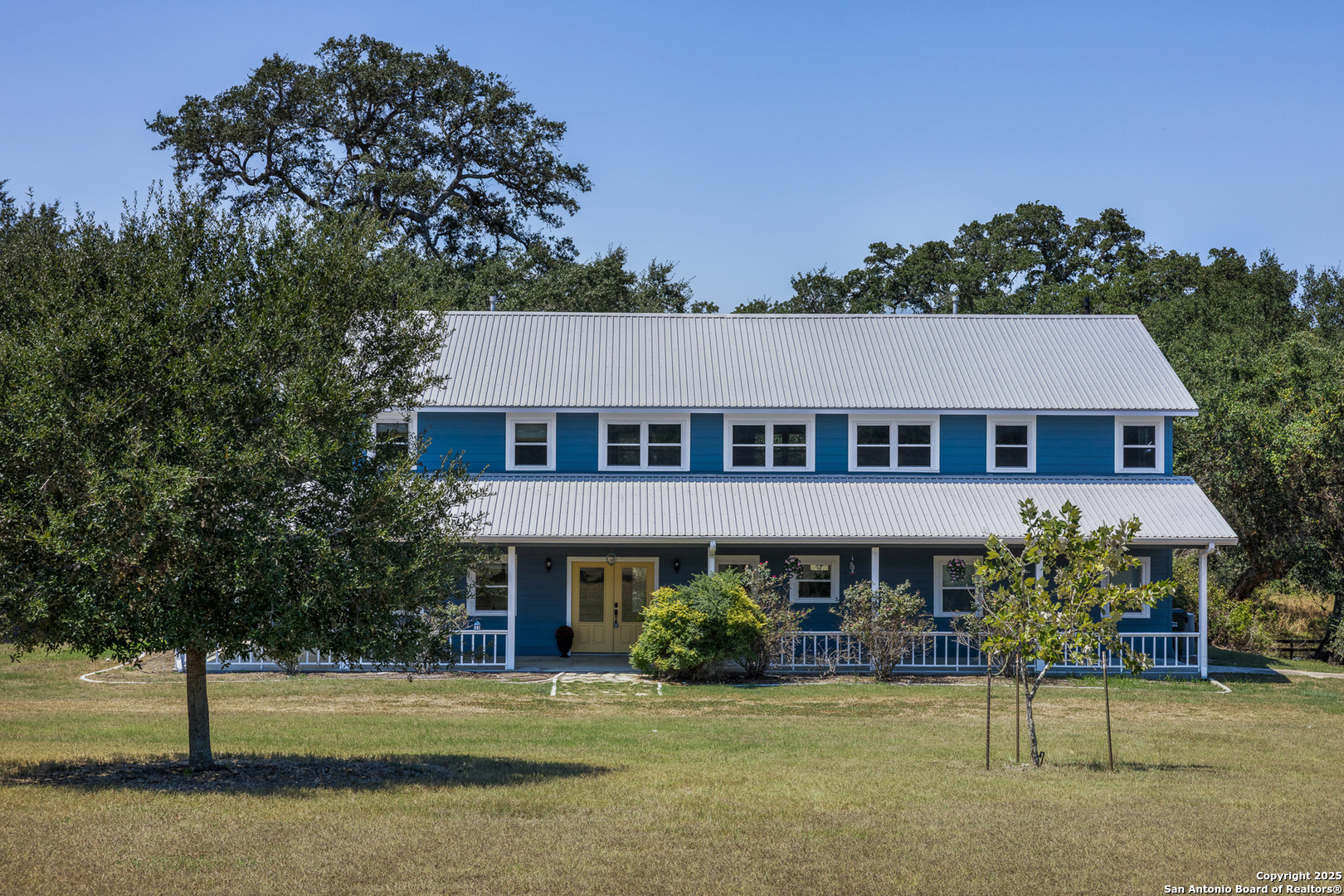 a view of a house with garden and trees