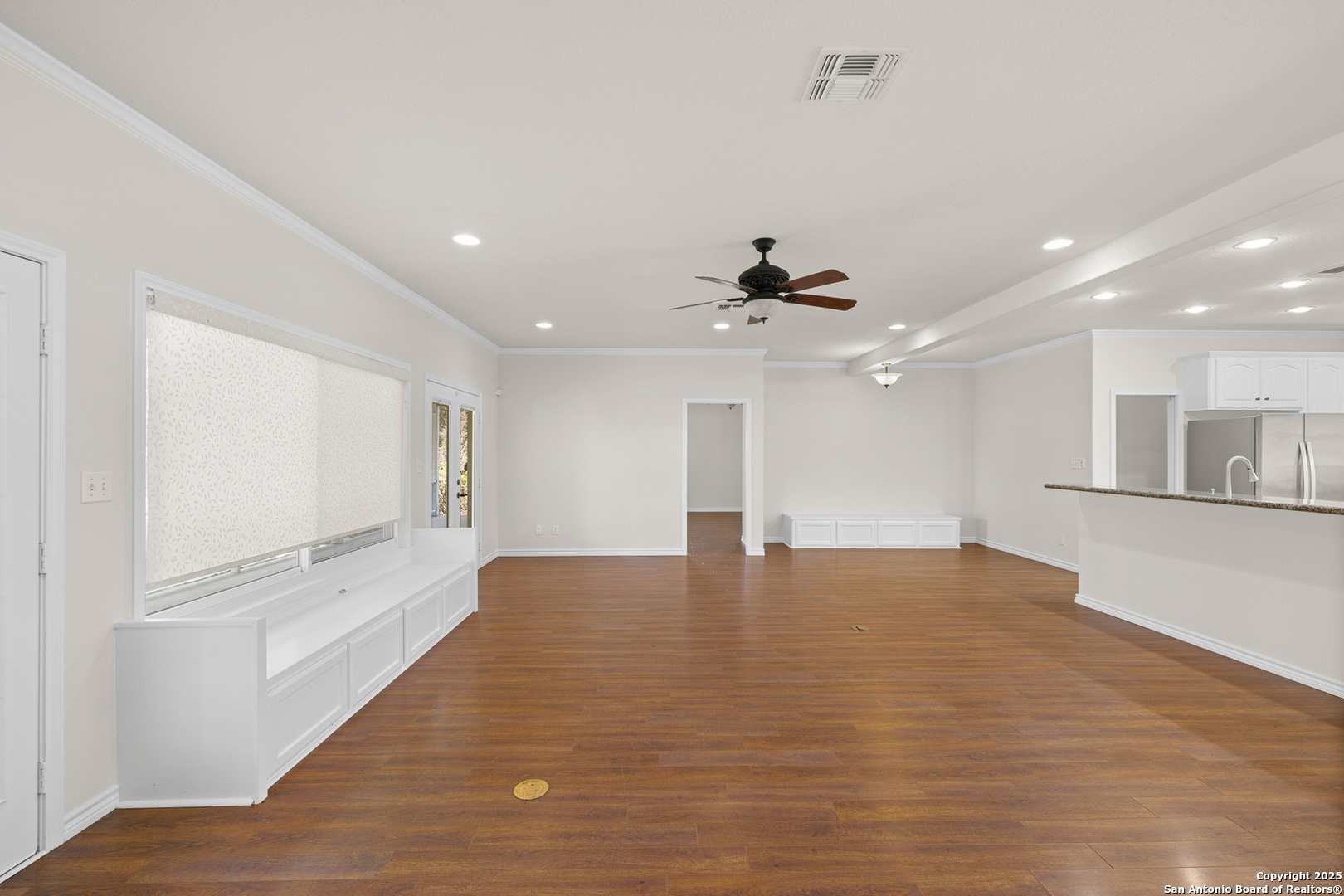 5450 Mazurek Road Schulenburg, TX 78956 - Photo 12 of 68 a view of an empty room with wooden floor and a ceiling fan