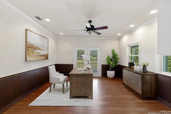 a kitchen with stainless steel appliances granite countertop a table chairs sink and cabinets