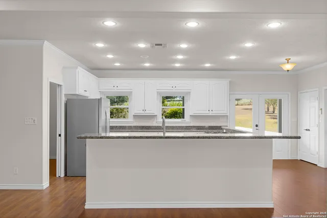 a bedroom with a large bed and a flat screen tv