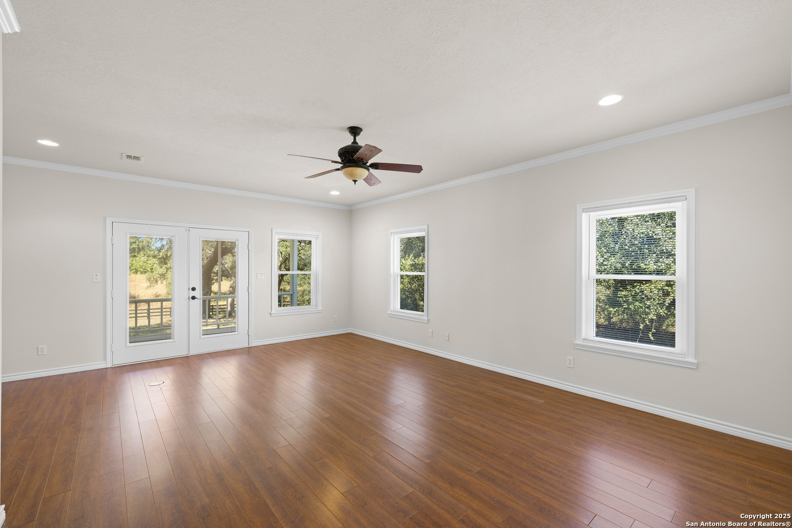 5450 Mazurek Road Schulenburg, TX 78956 - Photo 19 of 68 a view of an empty room with a window and wooden floor