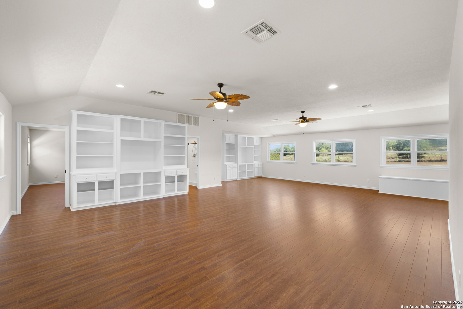 5450 Mazurek Road Schulenburg, TX 78956 - Photo 24 of 68 an empty room with wooden floor and windows