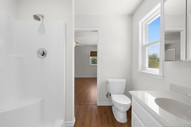 wooden floor in an empty room with a window