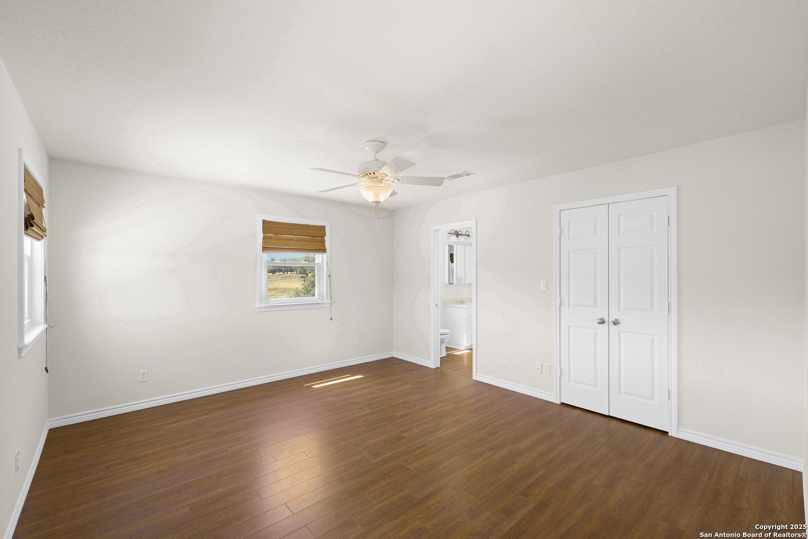 5450 Mazurek Road Schulenburg, TX 78956 - Photo 29 of 68 an empty room with wooden floor chandelier and windows