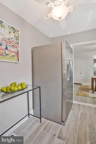 a view of a room with wooden floor and a chandelier