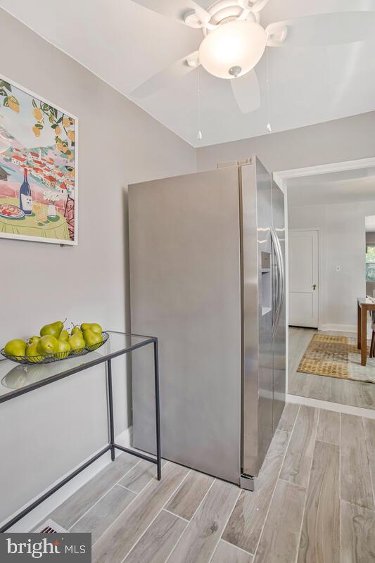 617 Annabel Avenue Baltimore, MD 21225 - Photo 19 of 40 a view of a room with wooden floor and a chandelier
