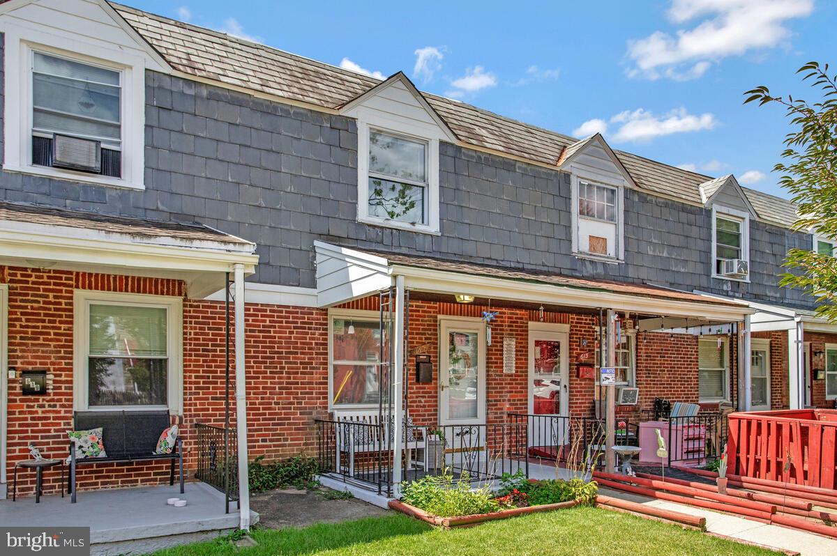 617 Annabel Avenue Baltimore, MD 21225 - Photo 2 of 40 front view of a brick building with a lots of windows and plants