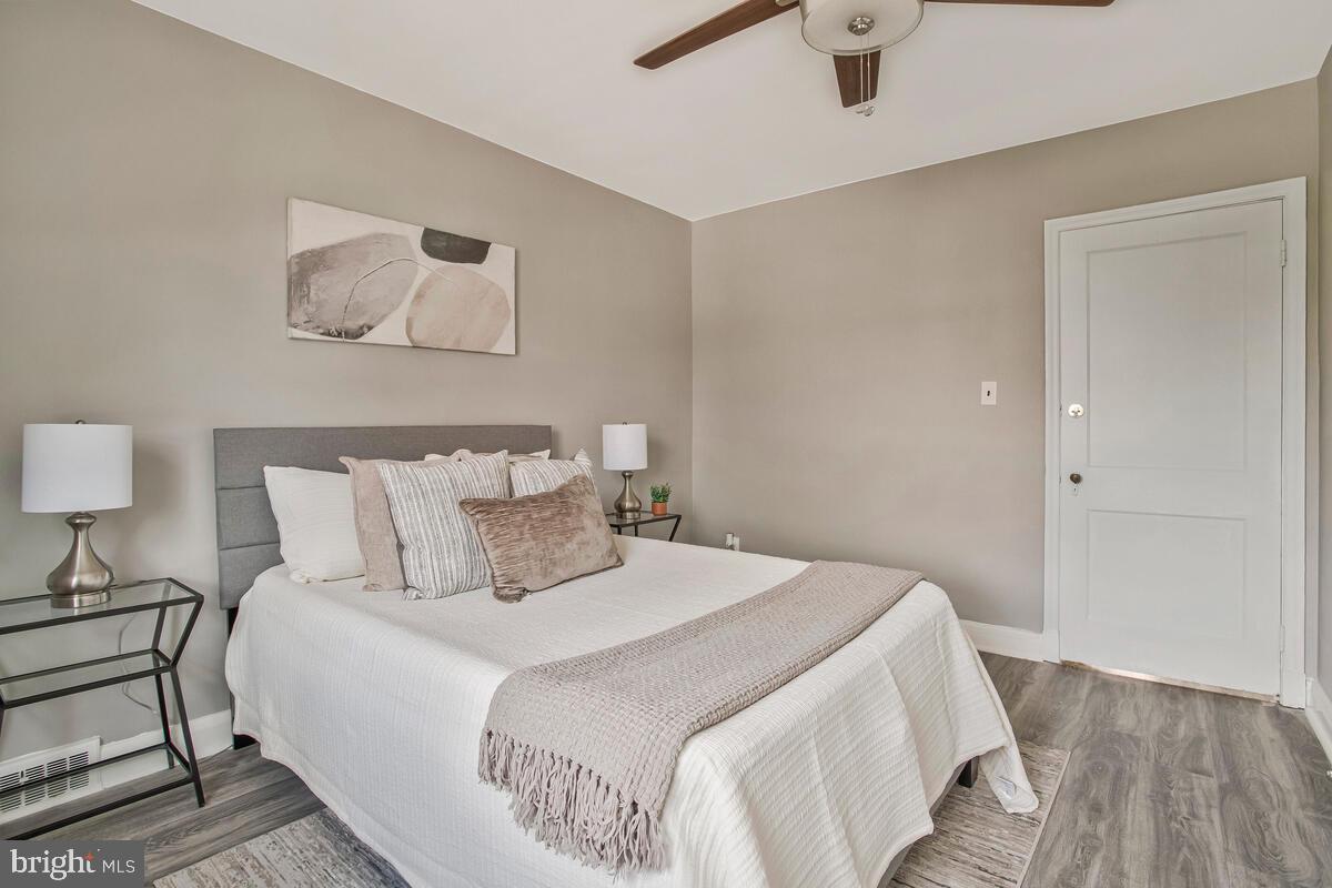 617 Annabel Avenue Baltimore, MD 21225 - Photo 24 of 40 a bedroom with a bed and a lamp on table