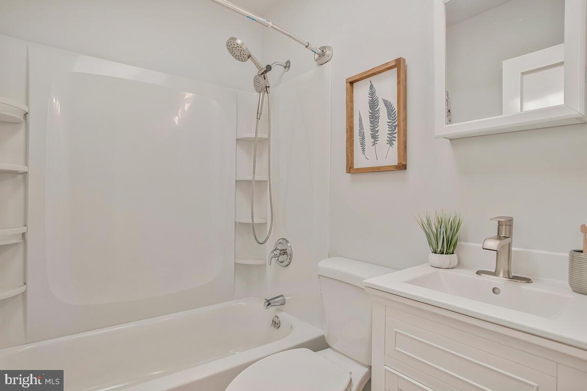617 Annabel Avenue Baltimore, MD 21225 - Photo 26 of 40 a bathroom with a sink a toilet and shower